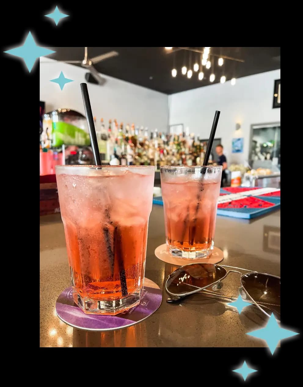 A picture of two pink cocktails on a table at The Roost.