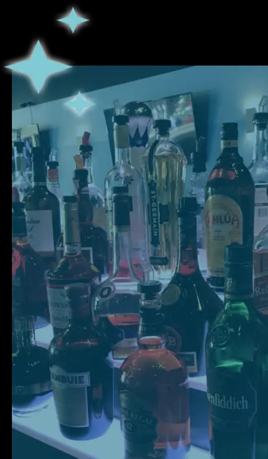 A vertical image of bottles of alcohol at the bar.